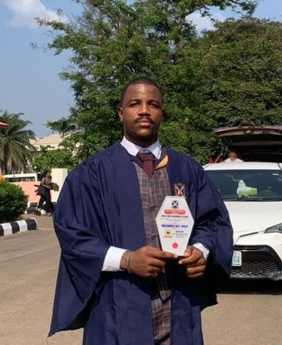 Graduate holding diploma